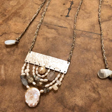 Load image into Gallery viewer, Measure Necklace: Four arching rainbows of white pearls, lace agate, labradorite, and a little silver buddah head, are suspended below a sterling silver bar sawed and textured to look like an abstract ruler. The necklace 'chain' is made up of hand-woven nylon thread.