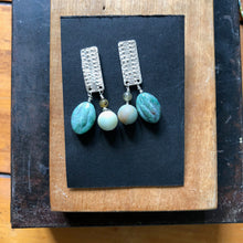 Load image into Gallery viewer, Textured Sterling Silver Rectangle Post Earrings with Carved Green Stone. on black card 
