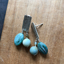 Load image into Gallery viewer, Textured Sterling Silver Rectangle Post Earrings with Carved Green Stone - earrings set on wood background one earring on its side to show post back