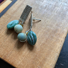Load image into Gallery viewer, Textured Sterling Silver Rectangle Post Earrings with Carved Green Stone - earrings set on wood background one earring on its side to show post back