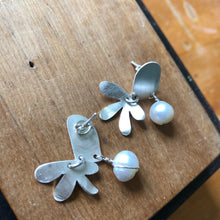 Load image into Gallery viewer, Door and Flower Sterling Silver Post Earrings with White Pearl sitting on wood block, one earring is upside down showing post back