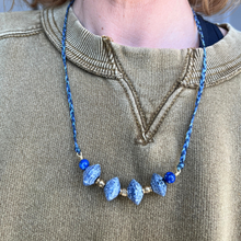 Load image into Gallery viewer, Necklace: recycled blue glass beads, brass beads, lapis on woven nylon thread
