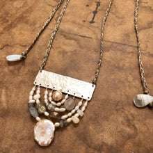 Load image into Gallery viewer, Measure Necklace: Four arching rainbows of white pearls, lace agate, labradorite, and a little silver buddah head, are suspended below a sterling silver bar sawed and textured to look like an abstract ruler. The necklace &#39;chain&#39; is made up of hand-woven nylon thread.
