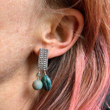Load image into Gallery viewer, Textured Sterling Silver Rectangle Post Earrings with Carved Green Stone on ear. model has pink hair 
