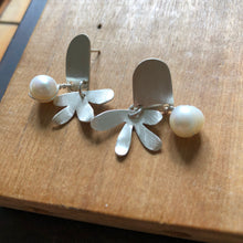 Load image into Gallery viewer, Door and Flower Sterling Silver Post Earrings with White Pearl sitting on wood block
